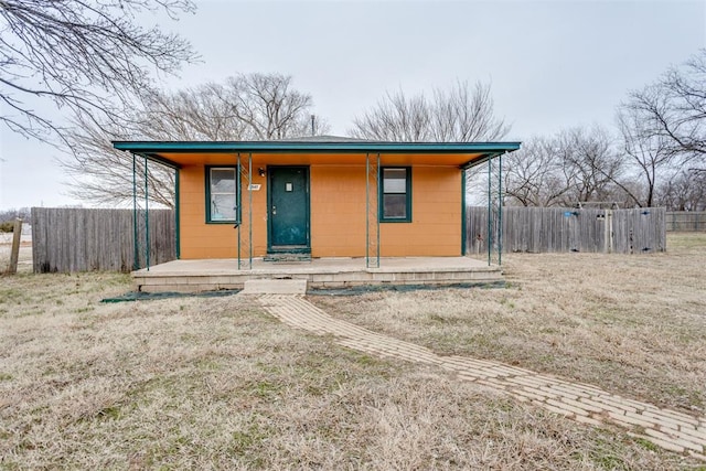 bungalow featuring a front yard and fence