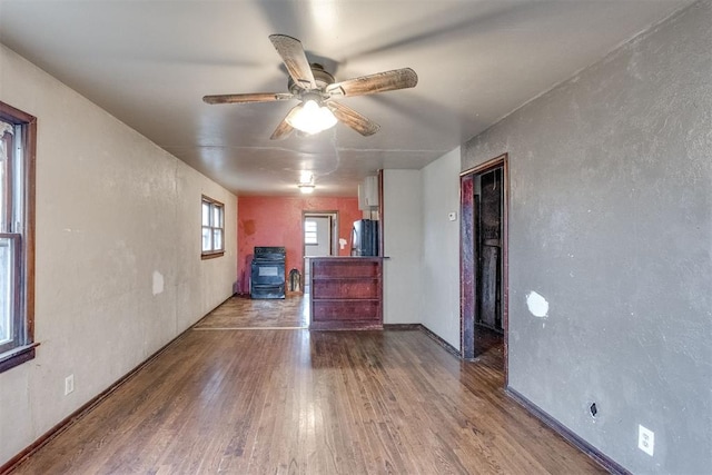 unfurnished living room featuring ceiling fan and wood finished floors