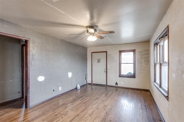 spare room with a ceiling fan and wood finished floors