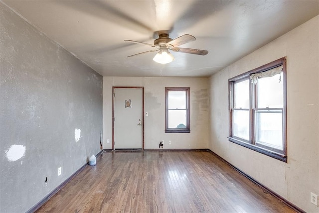 unfurnished room with ceiling fan and hardwood / wood-style floors