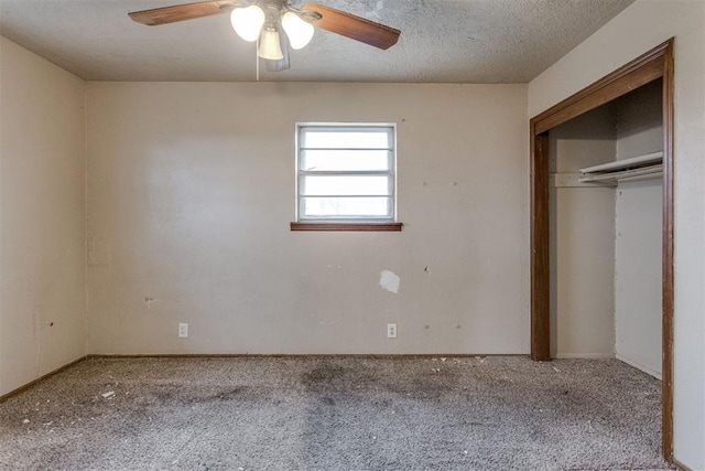 unfurnished bedroom with a textured ceiling, a closet, carpet flooring, and a ceiling fan