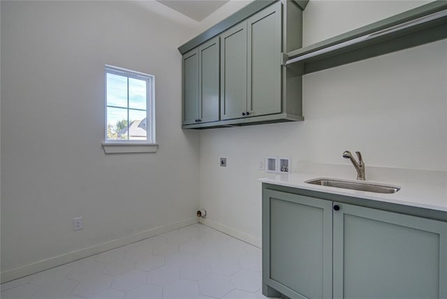 laundry room with hookup for an electric dryer, washer hookup, cabinets, sink, and light tile patterned floors