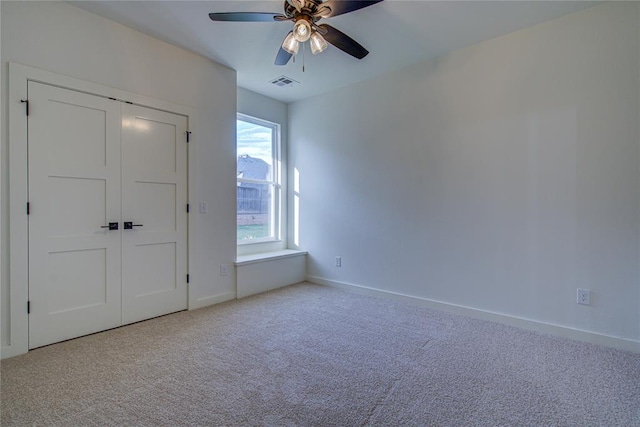 unfurnished bedroom with carpet floors, a closet, and ceiling fan