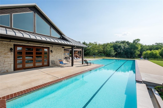 view of pool with a patio area and french doors