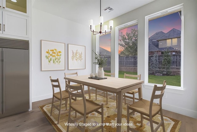 dining room featuring dark hardwood / wood-style flooring and a notable chandelier