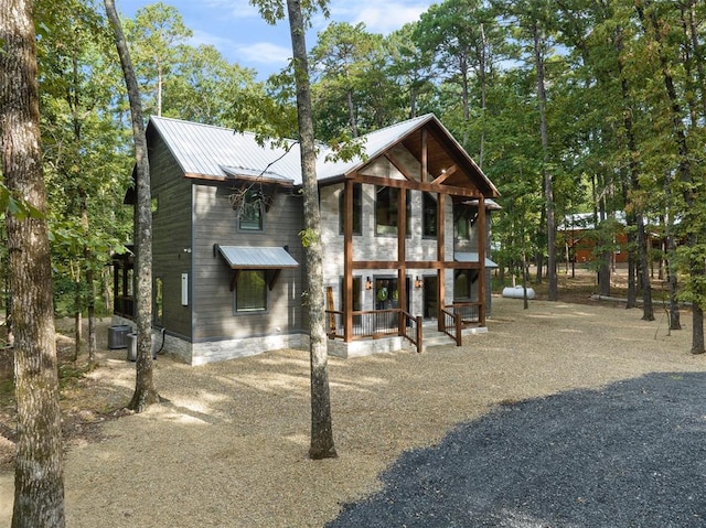 view of front of property with cooling unit and covered porch