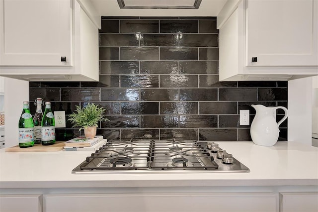 kitchen featuring tasteful backsplash, stainless steel gas cooktop, and white cabinets