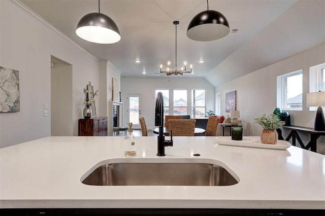 kitchen with sink, a wealth of natural light, and decorative light fixtures