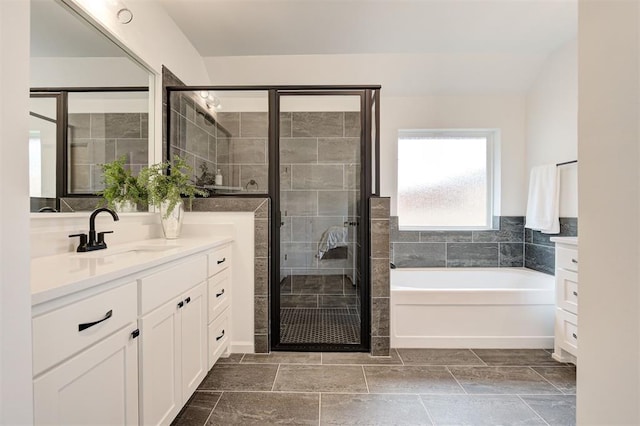 bathroom with vanity and independent shower and bath