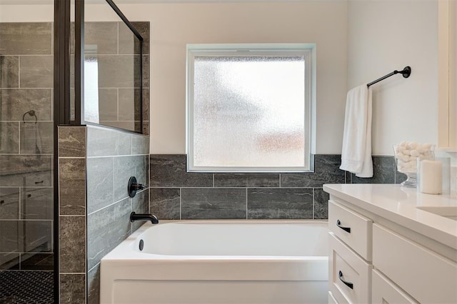 bathroom with vanity and independent shower and bath