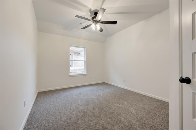 carpeted empty room with vaulted ceiling and ceiling fan