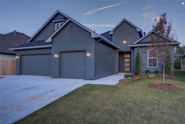 craftsman-style home with a yard and a garage