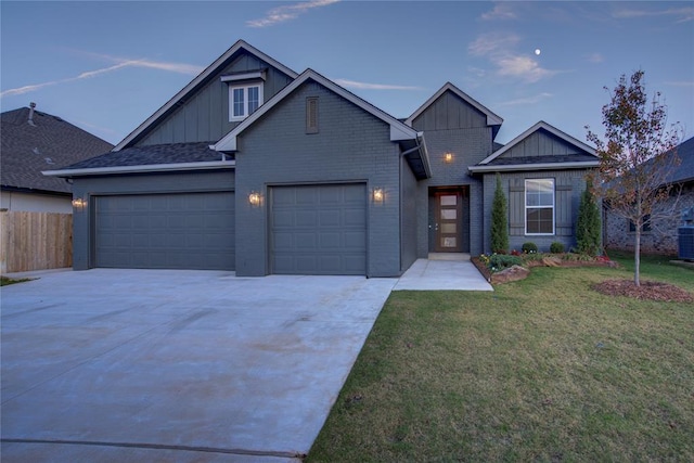 craftsman inspired home with a yard, central AC unit, and a garage