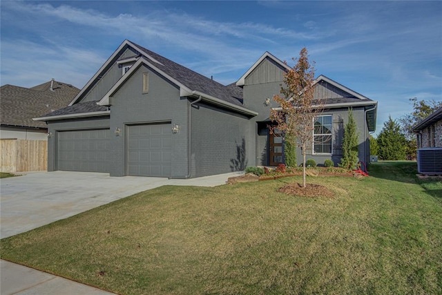 view of front of home with central AC, a front lawn, and a garage