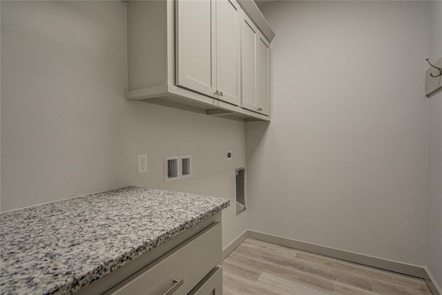 laundry room with cabinets, hookup for a washing machine, light hardwood / wood-style flooring, and hookup for an electric dryer