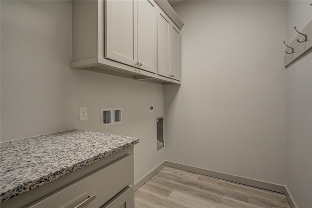 laundry room with cabinets, washer hookup, light hardwood / wood-style floors, and hookup for an electric dryer