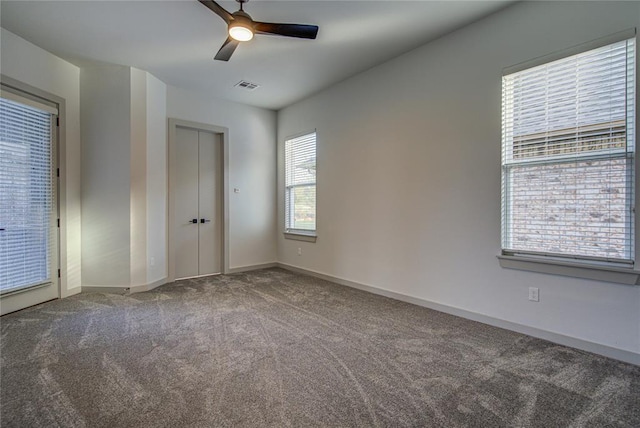 unfurnished bedroom with multiple windows, ceiling fan, and carpet floors