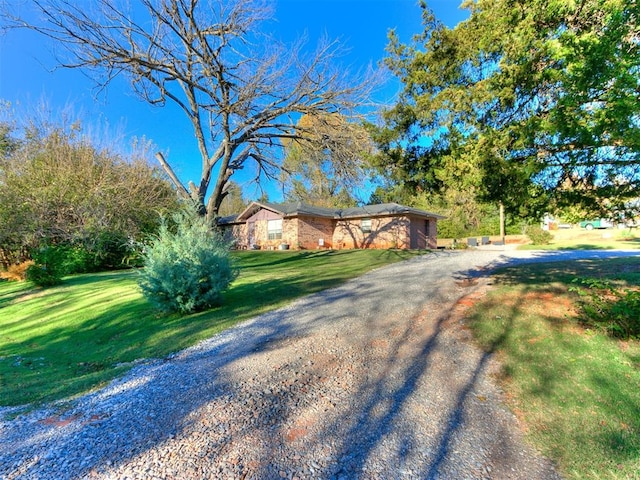 ranch-style home with a front lawn