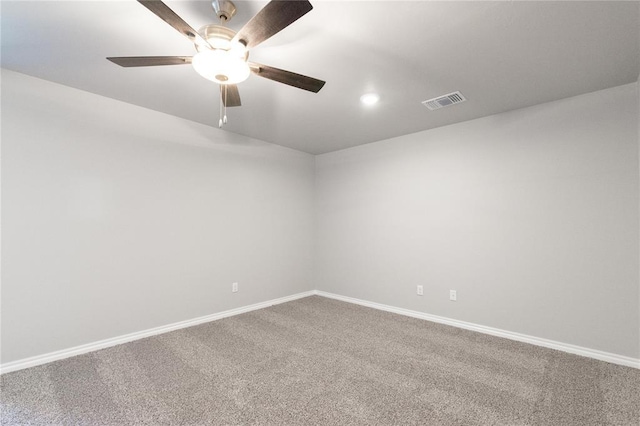 spare room with visible vents, baseboards, ceiling fan, and carpet