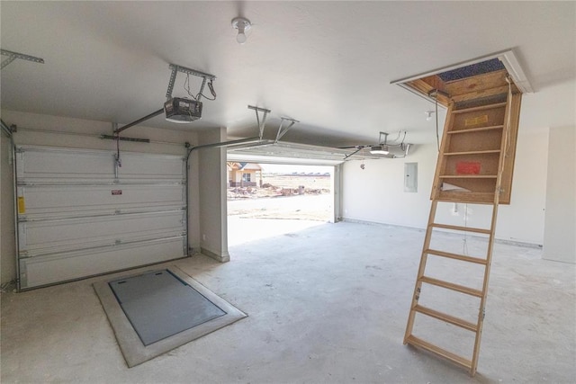 garage with a garage door opener and electric panel