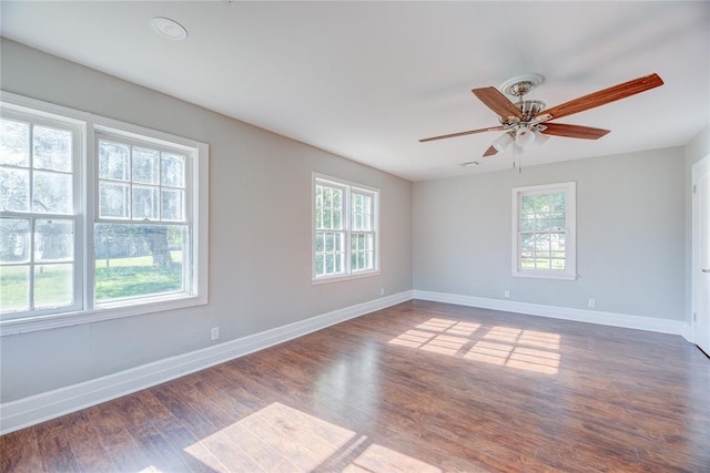 spare room with ceiling fan and dark hardwood / wood-style flooring