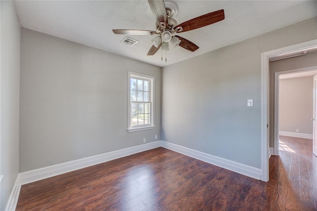 spare room featuring dark hardwood / wood-style flooring and ceiling fan