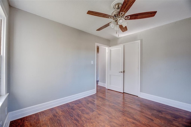 spare room with ceiling fan and dark hardwood / wood-style flooring