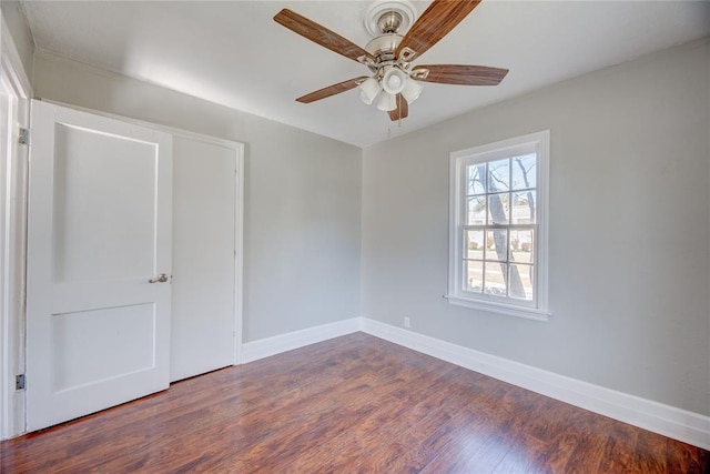 empty room featuring dark hardwood / wood-style floors and ceiling fan