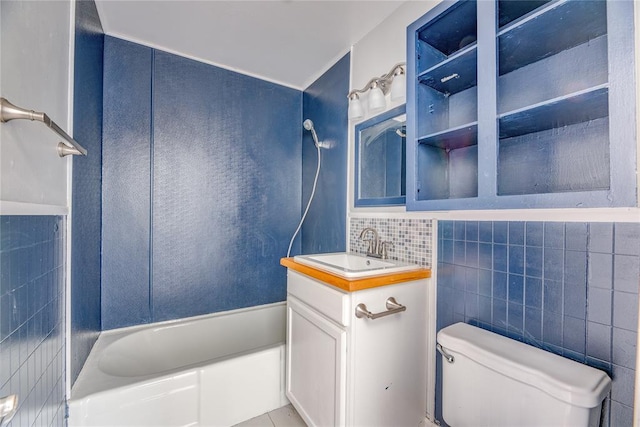 full bathroom featuring vanity, shower / washtub combination, toilet, and tile walls