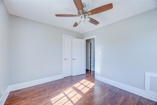 unfurnished room featuring dark hardwood / wood-style floors and ceiling fan