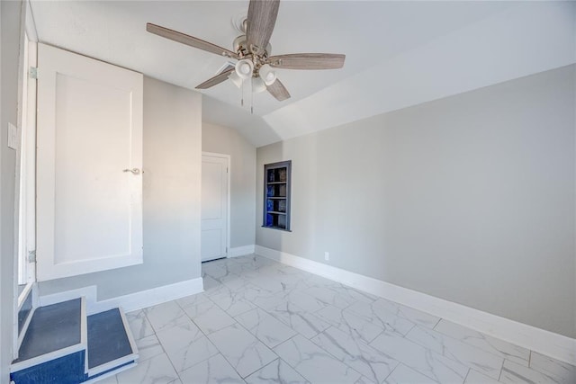 empty room with ceiling fan and vaulted ceiling