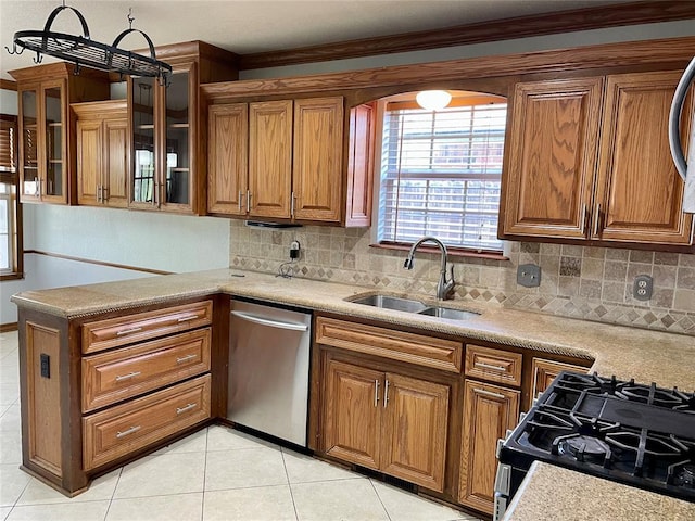 kitchen featuring dishwasher, crown molding, sink, decorative backsplash, and range with gas cooktop