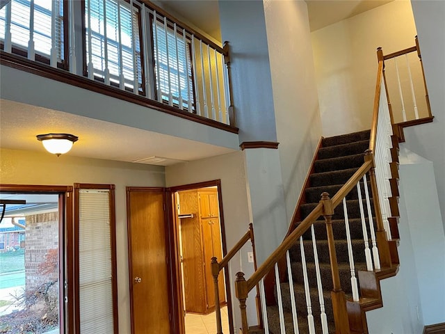 stairway with tile patterned floors