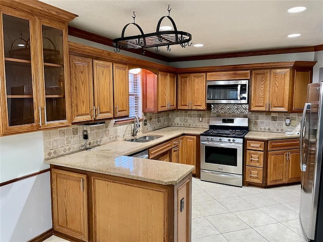 kitchen with light tile patterned flooring, sink, appliances with stainless steel finishes, kitchen peninsula, and backsplash