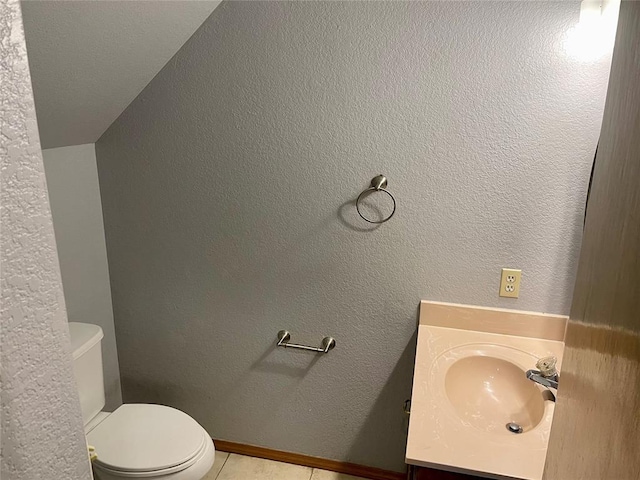 bathroom with vanity, tile patterned flooring, and toilet