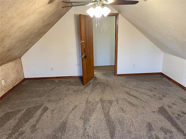 bonus room with lofted ceiling, a textured ceiling, and carpet flooring