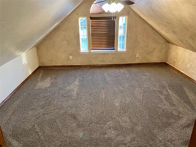 additional living space featuring ceiling fan, carpet, and vaulted ceiling