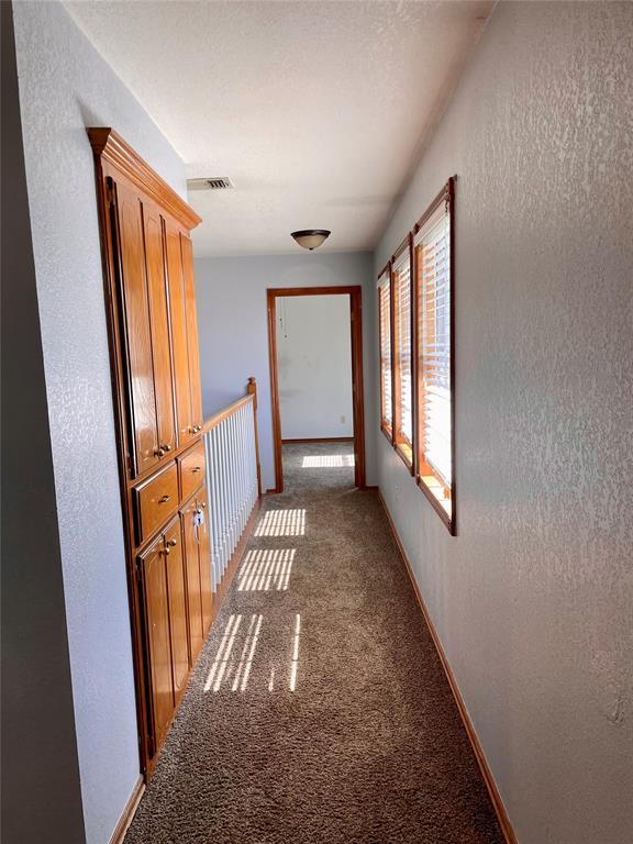 hallway featuring carpet