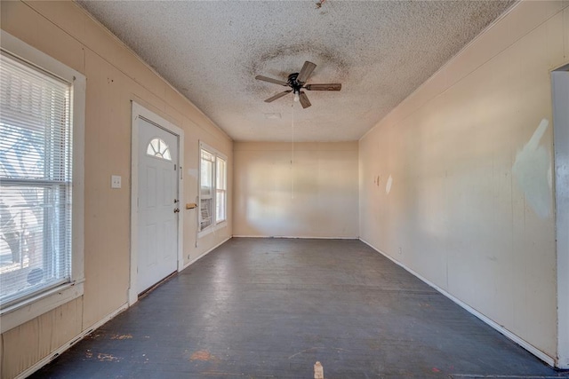 foyer with a textured ceiling, plenty of natural light, and ceiling fan