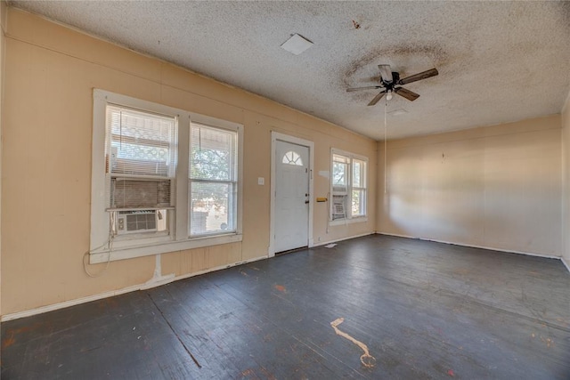 entryway featuring a textured ceiling, ceiling fan, and dark wood-type flooring