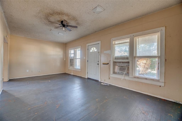 entryway featuring ceiling fan, cooling unit, dark hardwood / wood-style flooring, and a textured ceiling