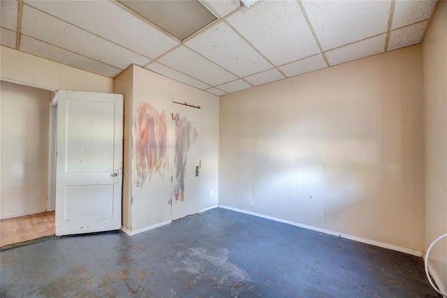 unfurnished room featuring a paneled ceiling