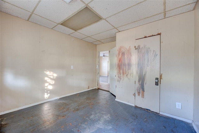 spare room featuring a drop ceiling and ceiling fan