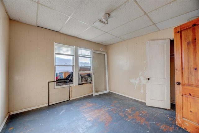 empty room with a paneled ceiling and cooling unit