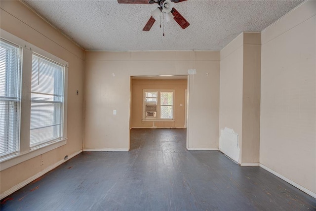 empty room featuring a textured ceiling, dark hardwood / wood-style flooring, and ceiling fan