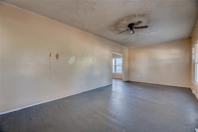 unfurnished room with a textured ceiling, ceiling fan, and dark wood-type flooring