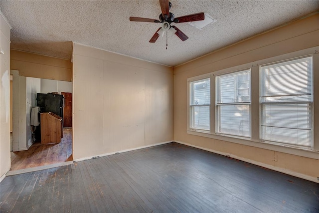 unfurnished room featuring a textured ceiling, ceiling fan, and dark wood-type flooring