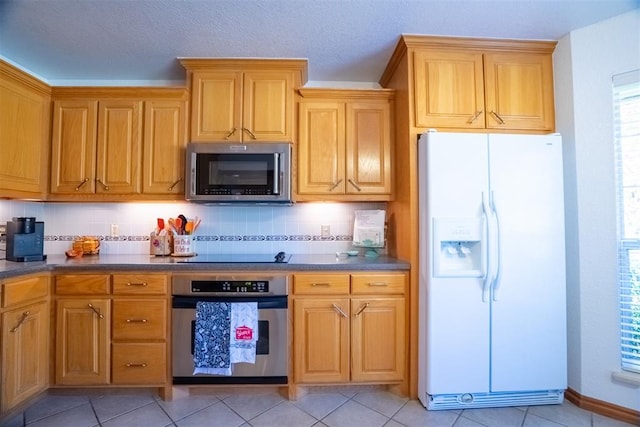 kitchen featuring decorative backsplash, light tile patterned flooring, and stainless steel appliances