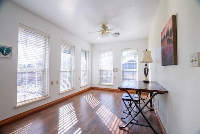 interior space with ceiling fan and dark wood-type flooring