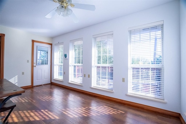 interior space with plenty of natural light, dark wood-type flooring, and ceiling fan